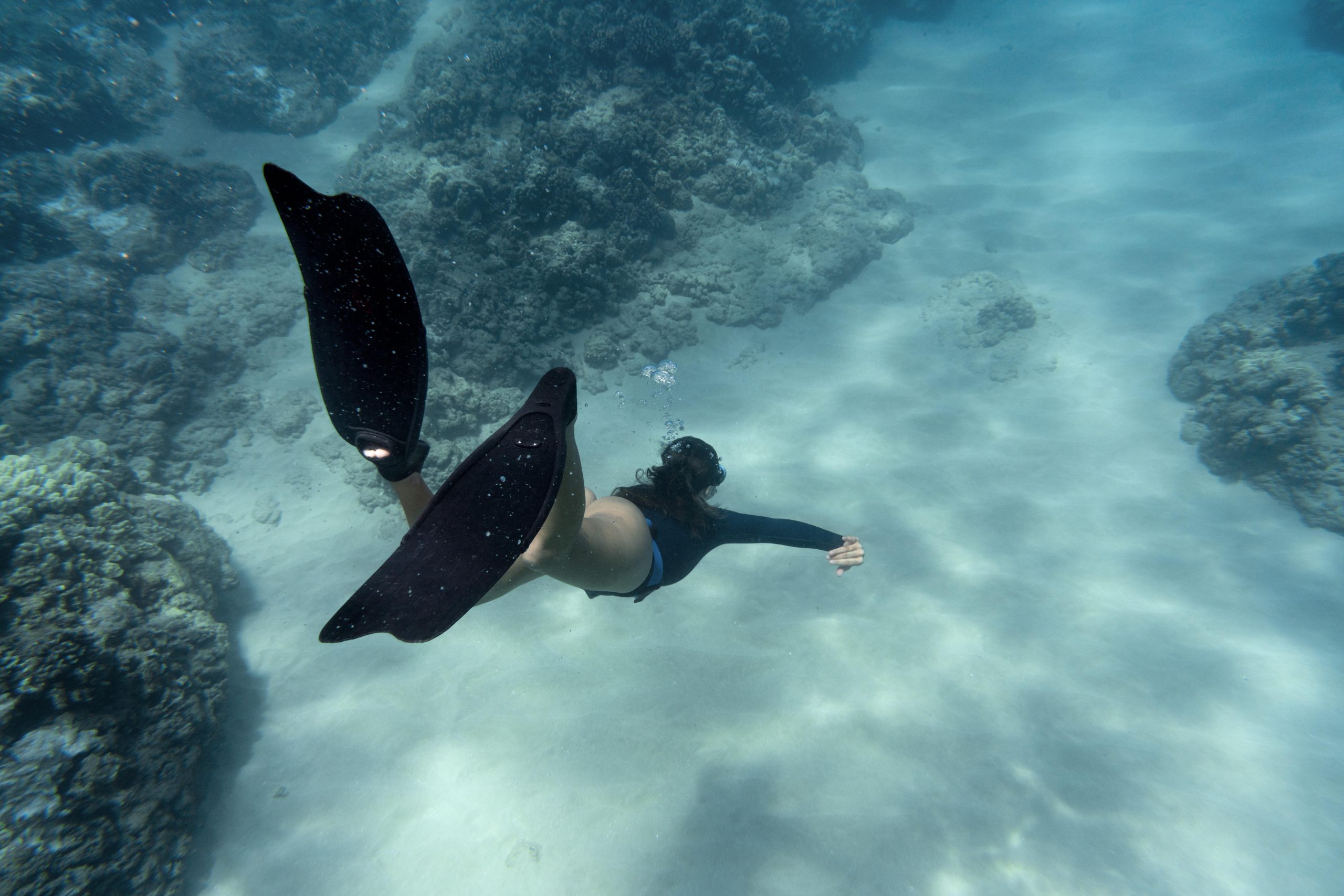 woman-with-flippers-swimming-ocean