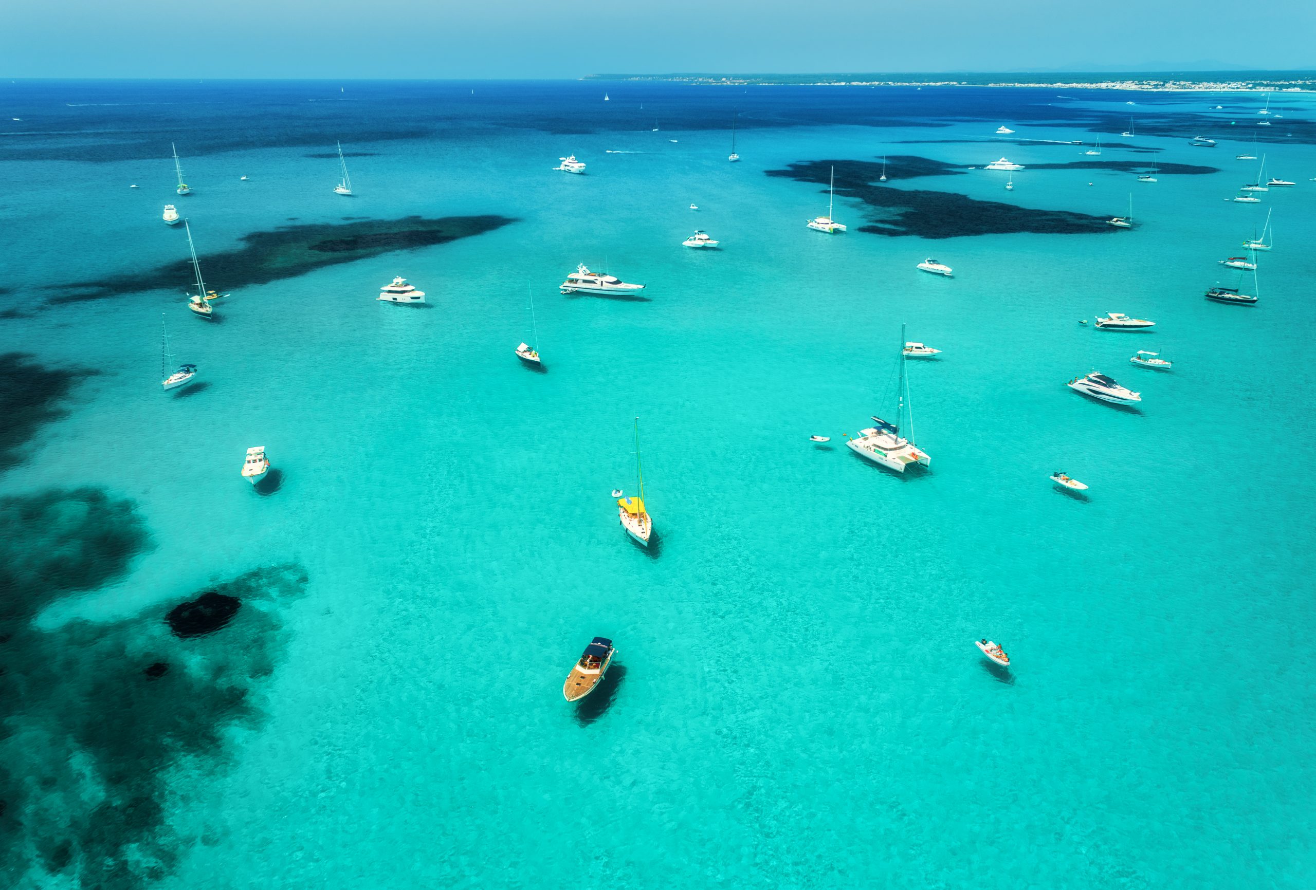 Aerial view of boats, luxury yachts and transparent sea